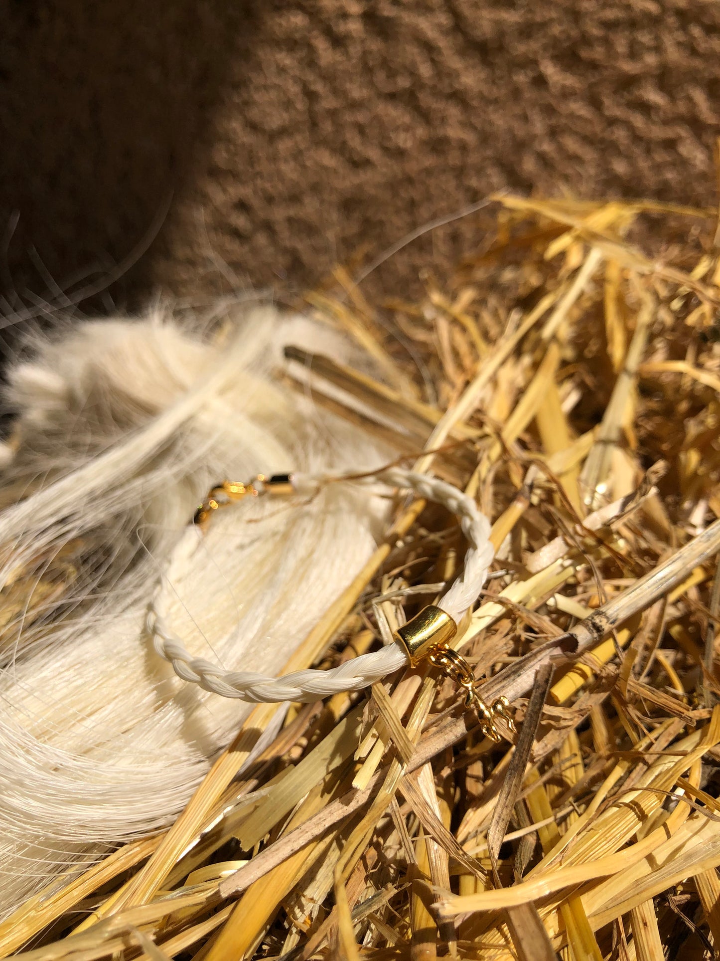 bracelet en crin de cheval avec tresse ronde et breloque cheval en acier inoxydable doré ou argenté.
